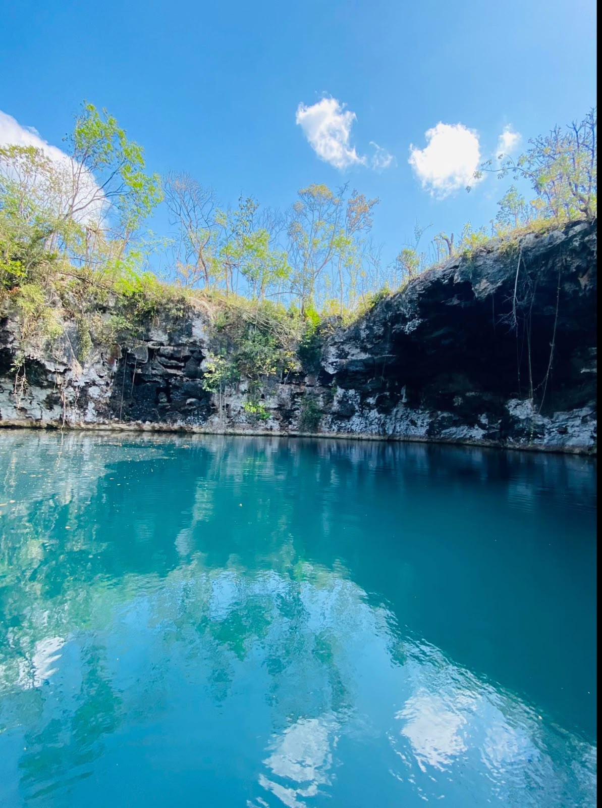 Open cenote, turquoise and sky